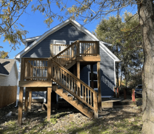 A house with stairs going up the side of it.