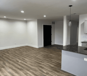 A room with hard wood floors and white walls.